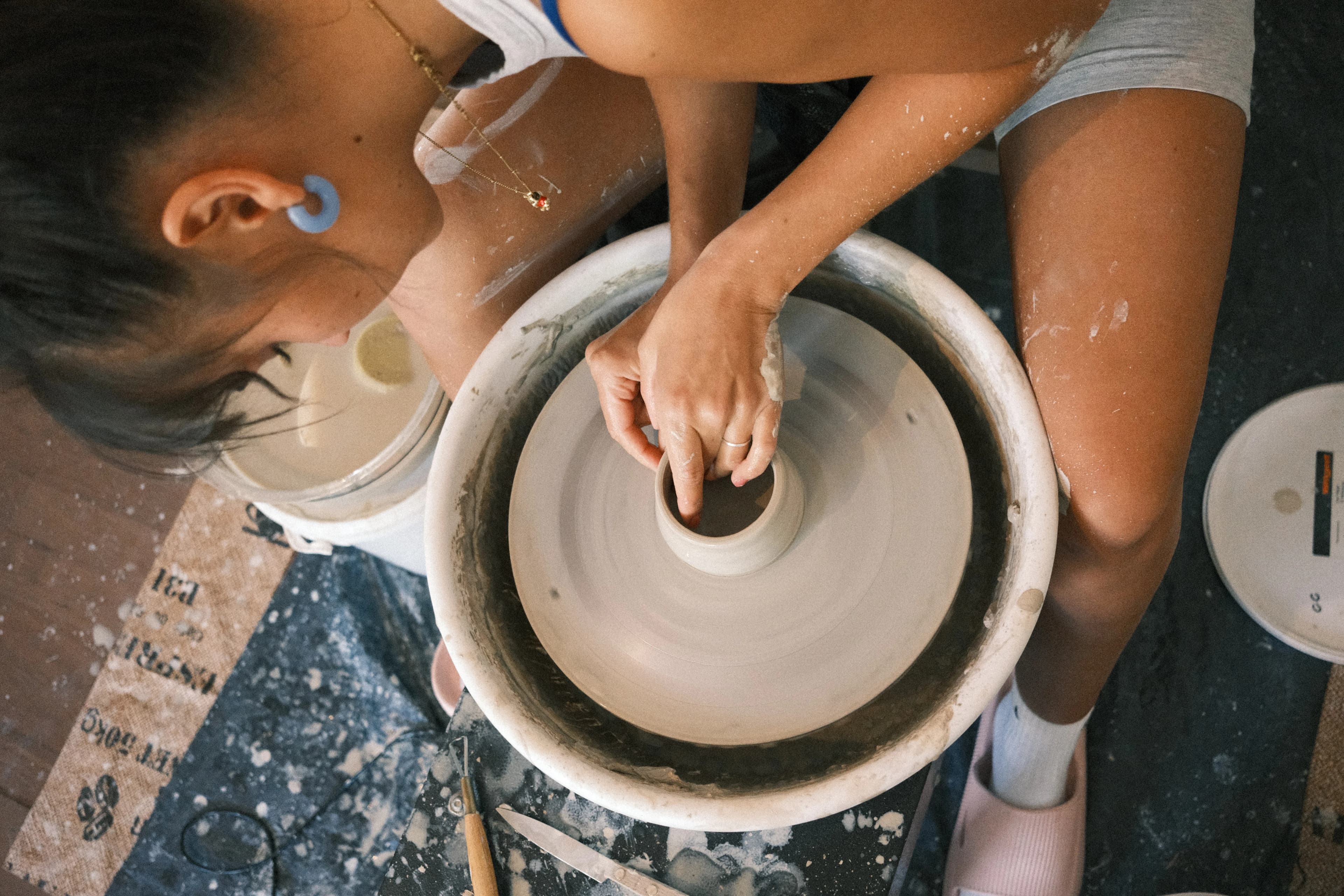 Rosely Campbell throwing at the pottery wheel